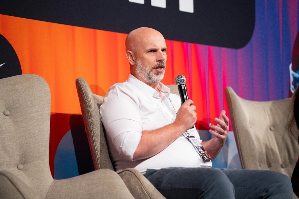 Colm McCourt speaking at a technology conference about AI and blockchain in healthcare